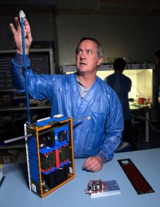 Dellingr Project Manager Chuck Clagett points to the CubeSat’s boom, at the end of which is a magnetometer, an instrument that takes measurements of its magnetic surroundings. Dellingr also carries two no-boom magnetometers, a first for such miniature satellites. Credits: NASA's Goddard Space Flight Center/Bill Hrybyk
