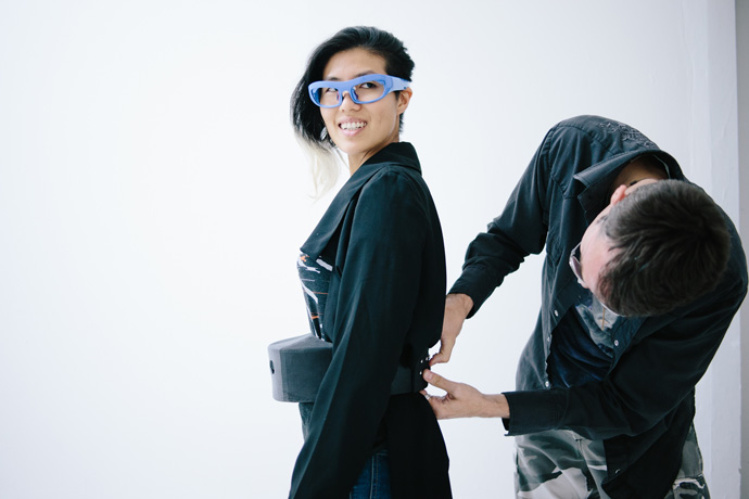 The glasses at Hussein Chalayans runway show on Sept. 30, 2016, are connected to a wearers belt. The belt includes an Intel Compute Stick, a tiny computing device the size of a pack of gum that captures the biometric data and translates it by projecting visualizations interpreting the wearers stress level onto a wall via a small Pico projector. Paris Fashion Weeks Spring/Summer 2017 event runs Sept. 27-Oct. 5, 2016. (Credit: Intel Corporation)